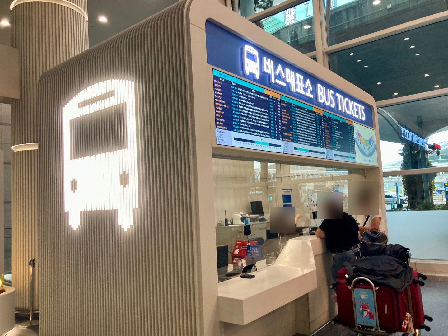 Bus ticket booth with a lit bus icon at Incheon Airport Terminal 1