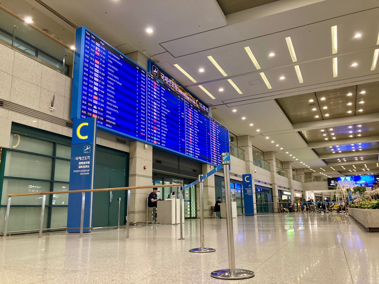 International Arrivals exit C with a large arrivals board at Incheon Airport Terminal 1
