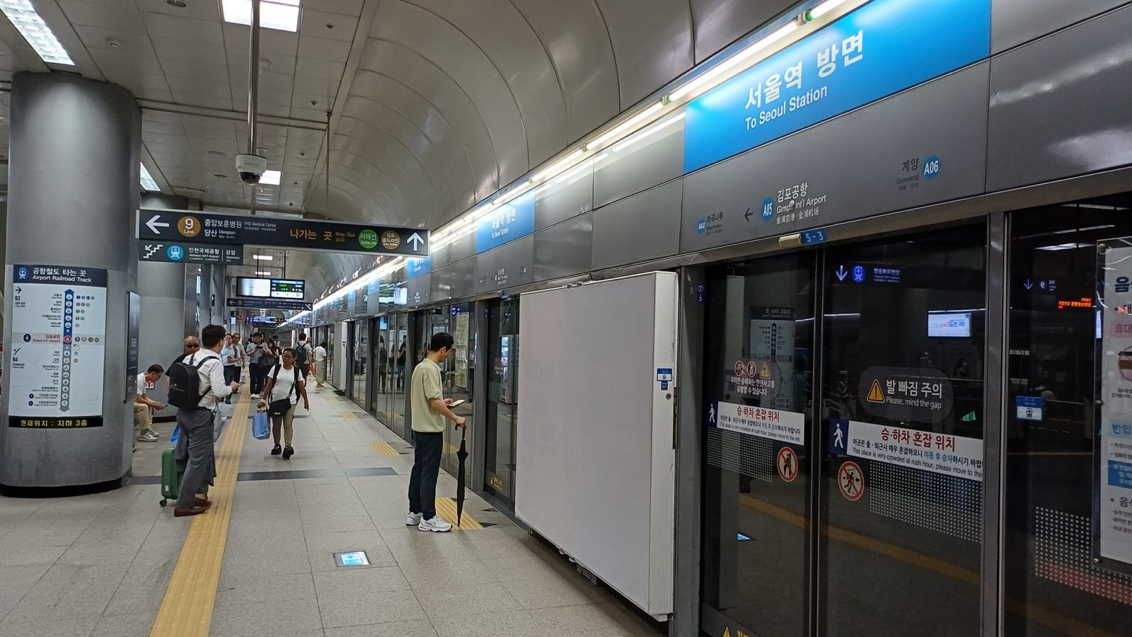 Airport Railroad platform at Gimpo Airport Station with screen doors and a To Seoul Station sign