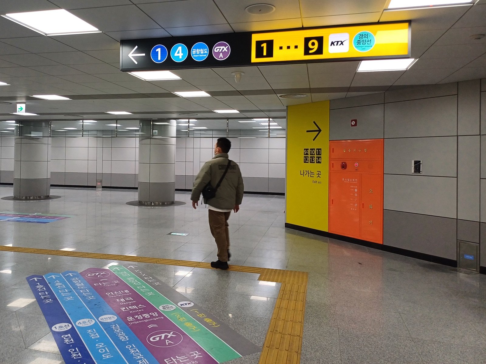 Signs for Lines 1 and 4, the Airport Railroad and GTX-A in a Seoul Station concourse